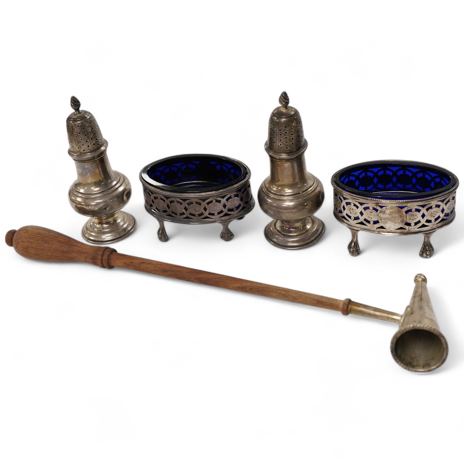 Sundry silver, consisting of - a pair of pepper pots, Birmingham, 1948 a pair of George III pierced oval salts, with blue glass liners and a modern silver candle snuffer with a turned wood handle.
